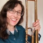 I'm smiling and holding a trombone!
